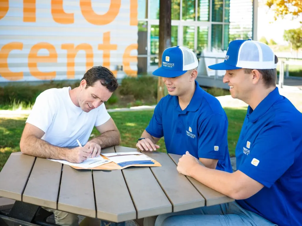 A First Choice Home Advisor walking a seller through closing documents